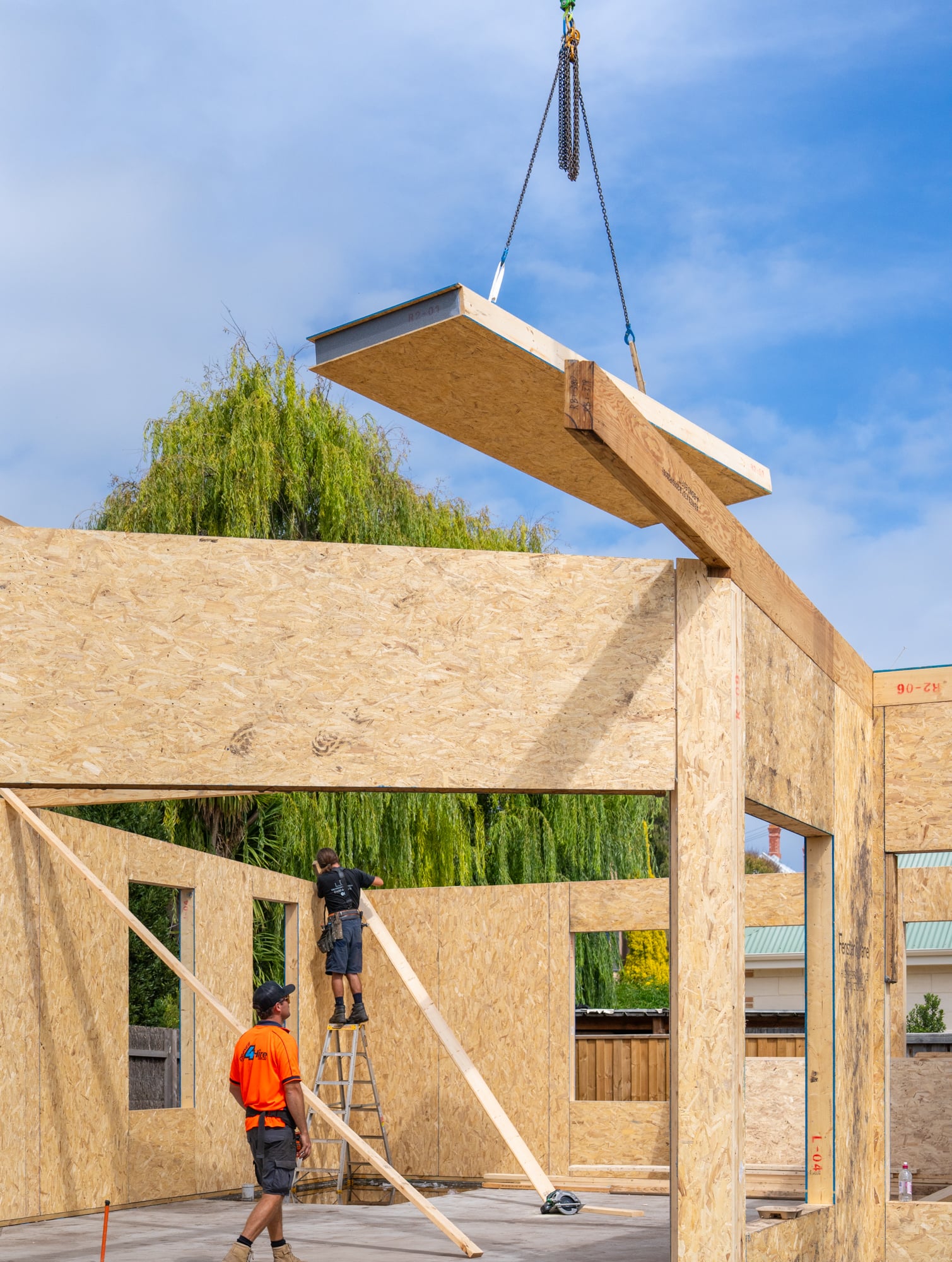 Prefabricated wall panels being assembled on a residential site
